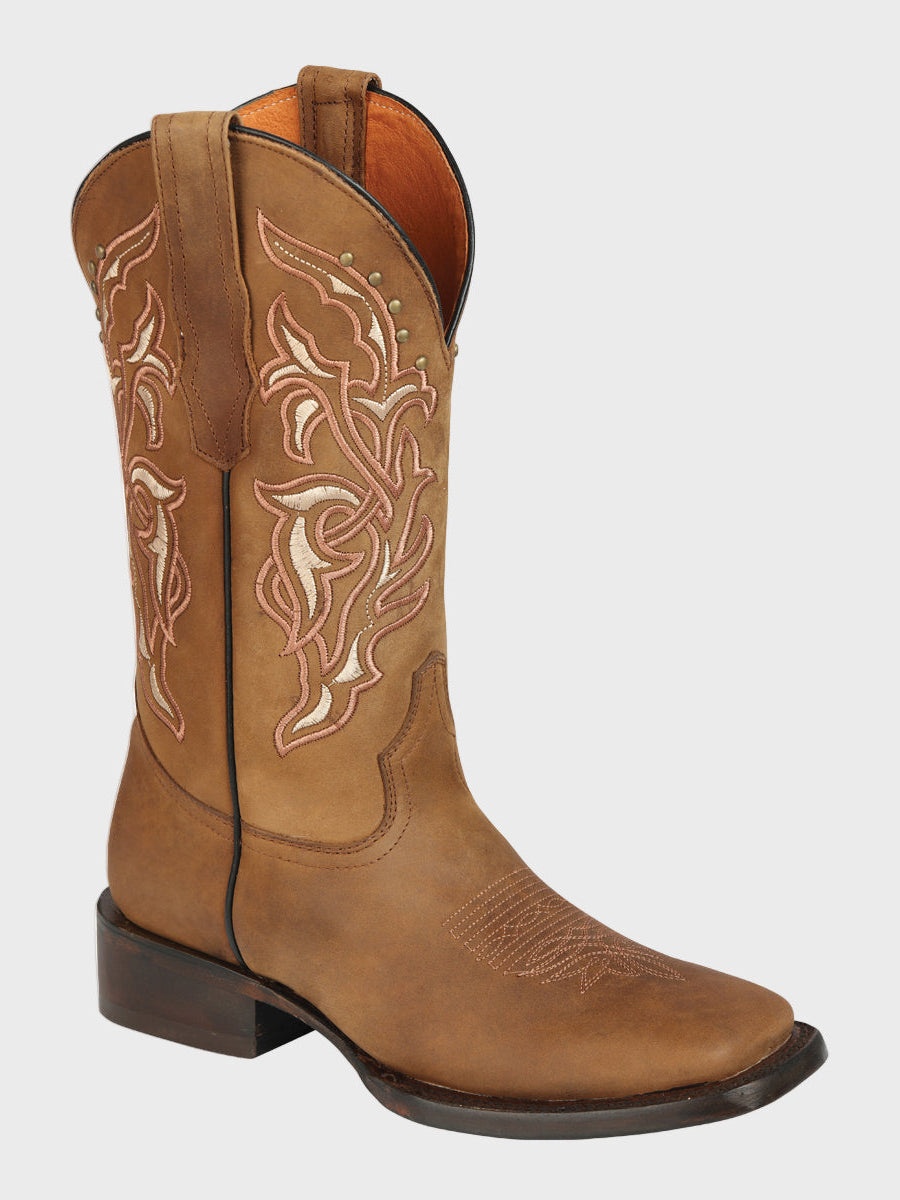 Brown cowboy boot with intricate white embroidery on a light gray background