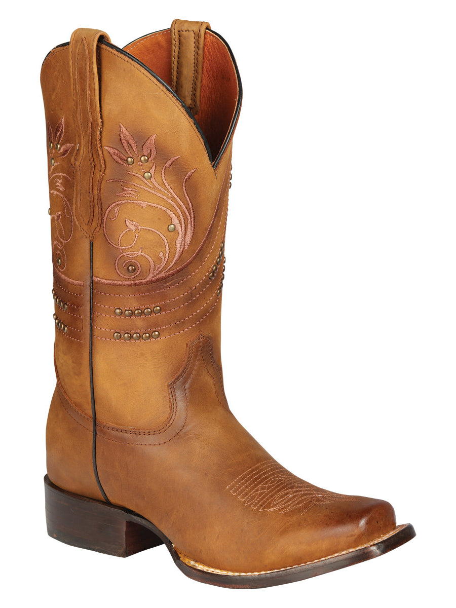 Brown cowboy boot with intricate embossing on a white background