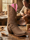 Master bootmaker crafting premium brown suede western boot with pink leather lining in León, Guanajuato workshop — traditional Mexican craftsmanship