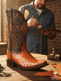 Atelier No. 51 men’s western boot in cognac ostrich leather resting on a workbench, handcrafted with visible quill texture and dark embroidered shaft, photographed in the atelier.
