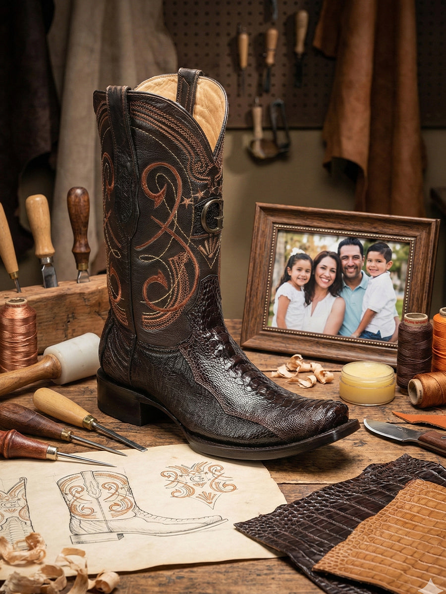 Finished Atelier No. 60 “El Ascenso” brown ostrich leather boot displayed in the atelier with tools and sketches, showing natural quill texture and hand-finished construction.
