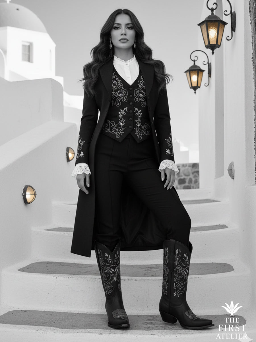 Black-and-white portrait of a woman in tailored attire wearing the La Flor del Egeo Boot — evening calm with structured strength.