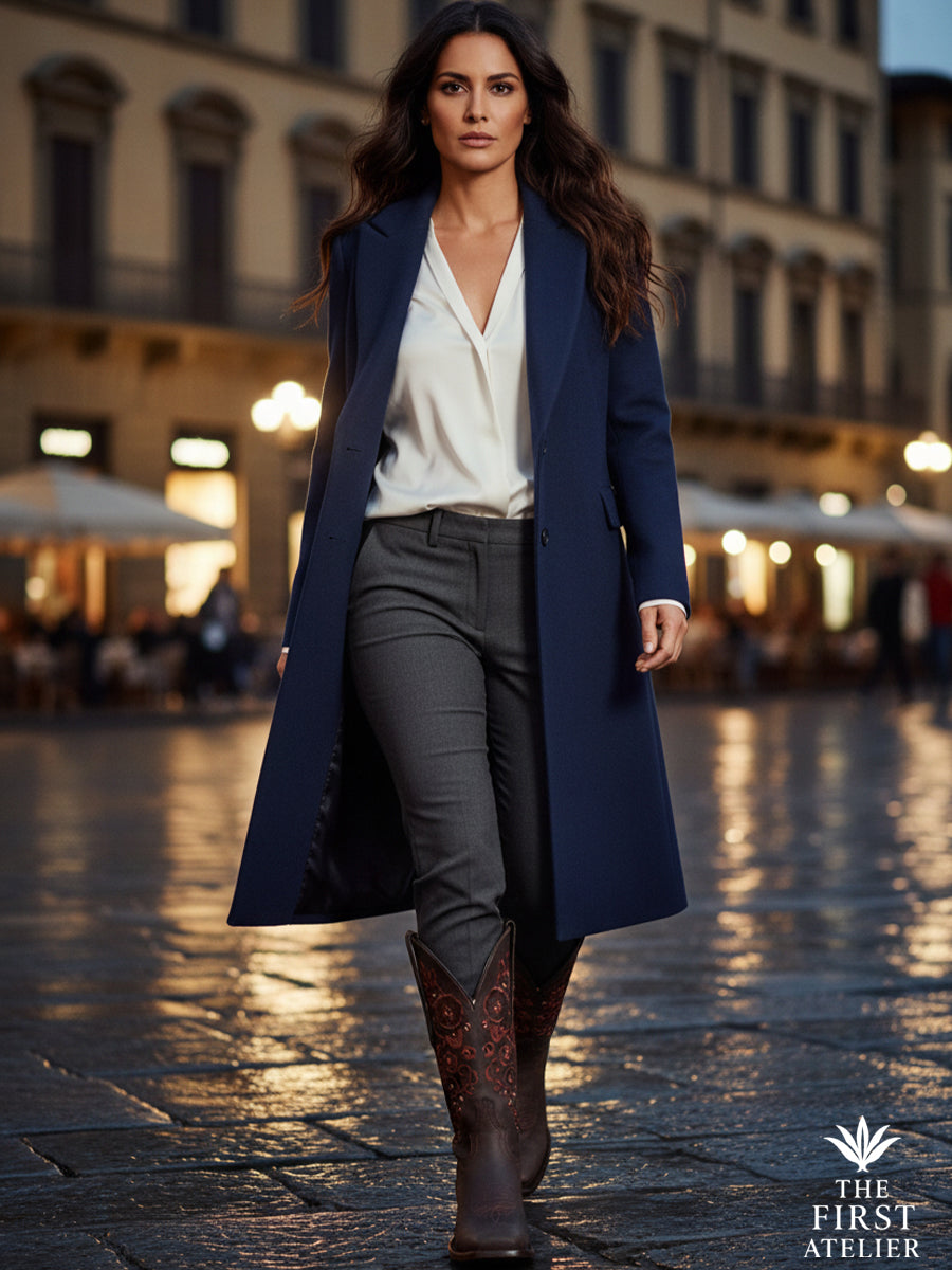 Elegant woman walking through an old European-style avenue at dusk wearing The Atelier Granada Boot — blending heritage craftsmanship with modern urban grace, Atelier No. 16.