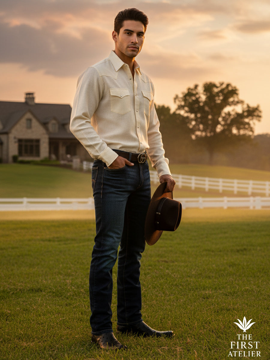 Man standing in a refined rural setting wearing The First Atelier Atelier No. 47 men’s western boots in black ostrich leather — understated elegance, natural posture, and authority expressed through restraint.
