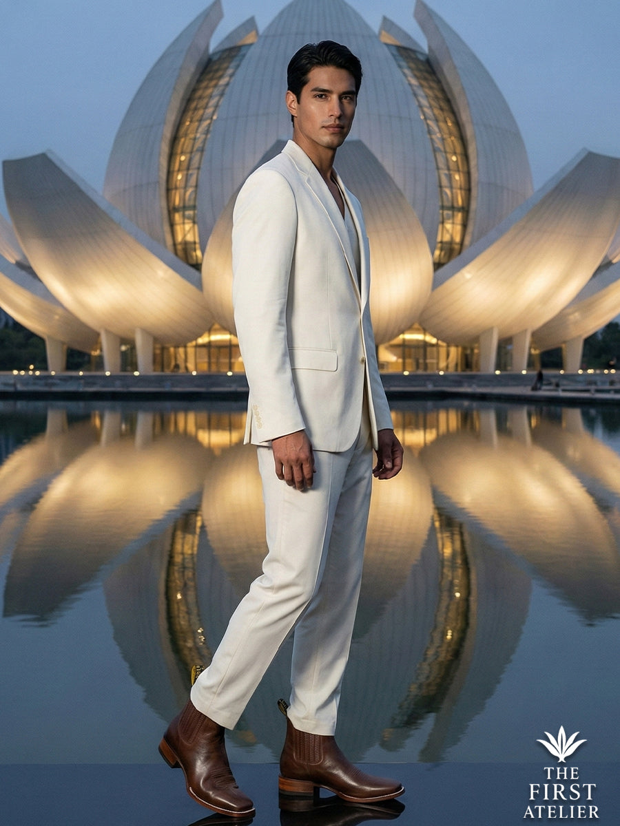 Men’s luxury editorial featuring Atelier No. 68 El Trazo Maestro Boot paired with a white suit against modern architectural curves.