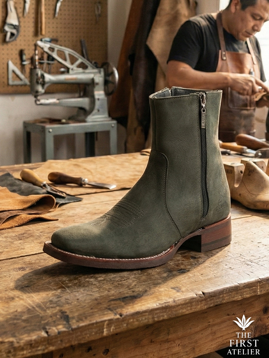 Master artisan finishing the Atelier No. 70 El Dominio Boot in rare olive green suede, highlighting the hand-lasted shape and side zipper