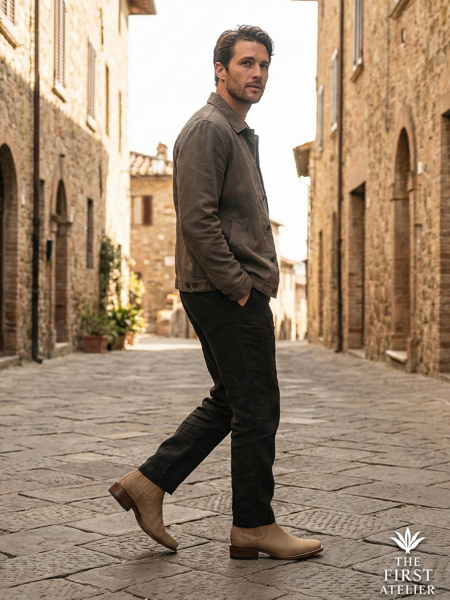 Street style shot of a gentleman walking on ancient cobblestones wearing the Western-Chelsea hybrid Atelier No. 73 El Sendero Boot.