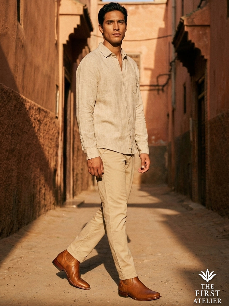 Gentleman walking in an earthy alleyway wearing beige chinos and Atelier No. 77 Chelsea boot, highlighting the warm cognac tone
