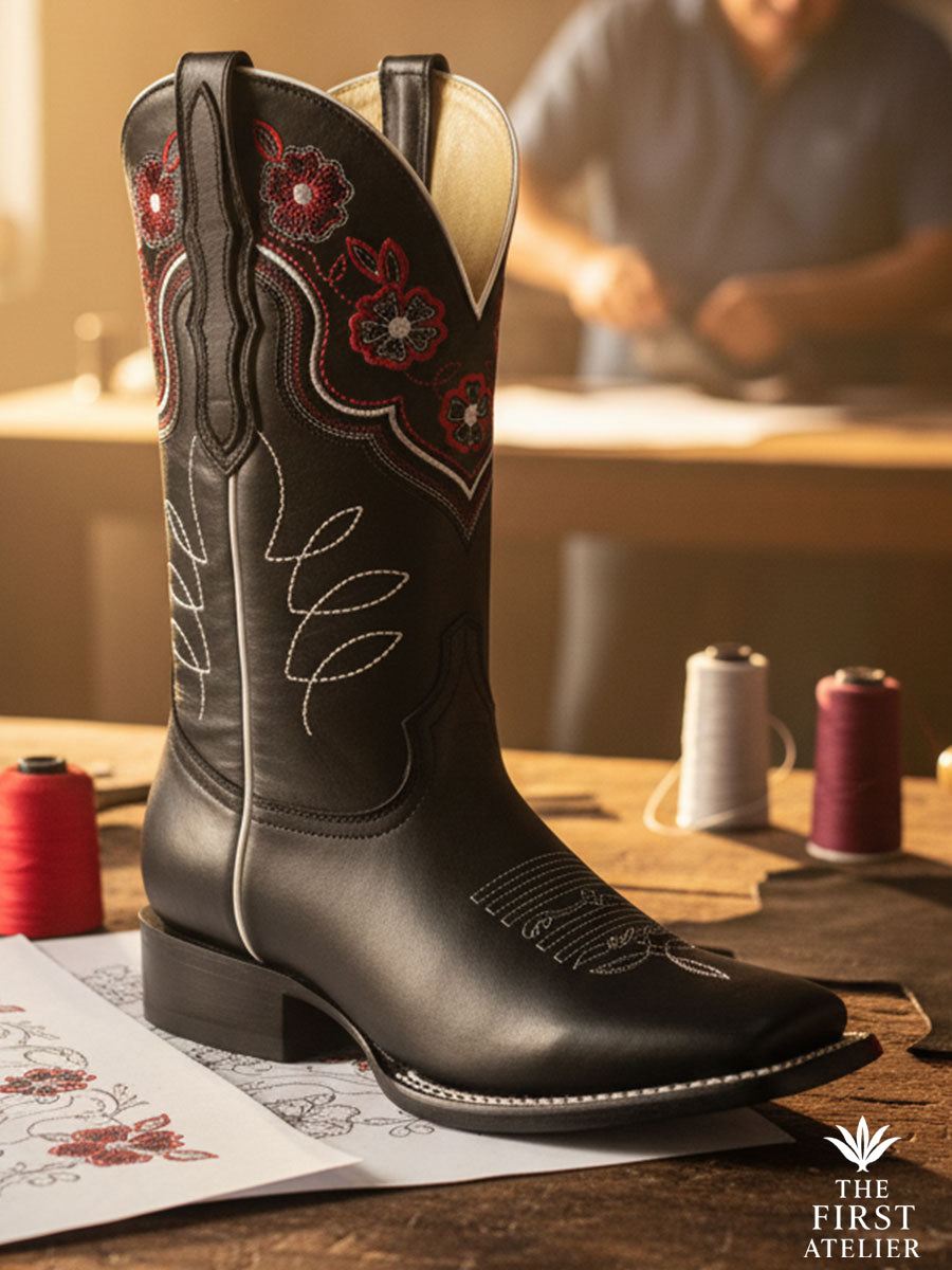 Handcrafted black leather boot with crimson rose embroidery, photographed in the artisan workshop, Atelier No. 26 — La Rosa del Invierno.