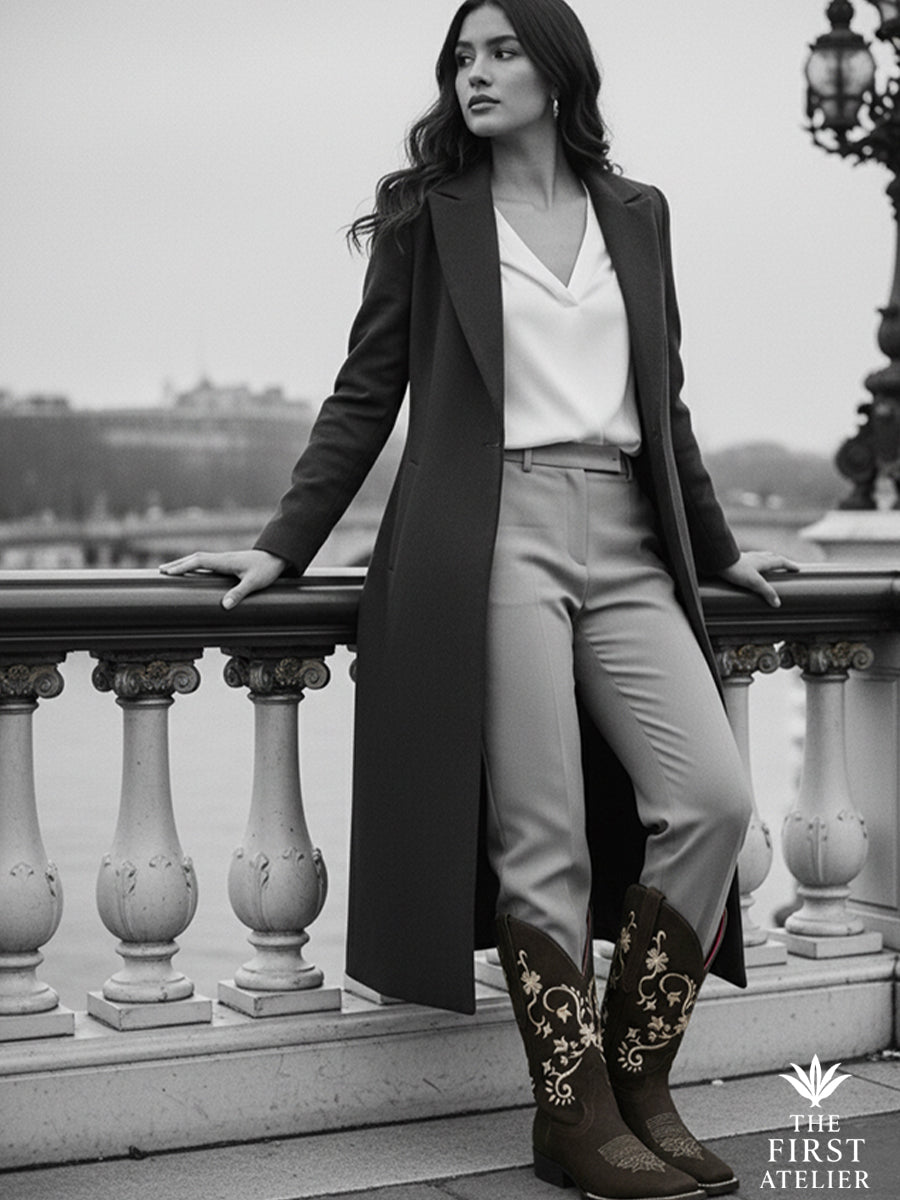 Black-and-white editorial of a woman overlooking a city bridge in La Flor de la Medianoche Boot — timeless confidence, Atelier No. 18.