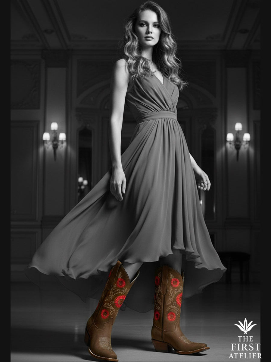 La Flor de la Vida Boot displayed in a craftsman’s studio surrounded by sketches, threads, and a red flower — a tribute to heritage and handmade beauty, Atelier No. 8.