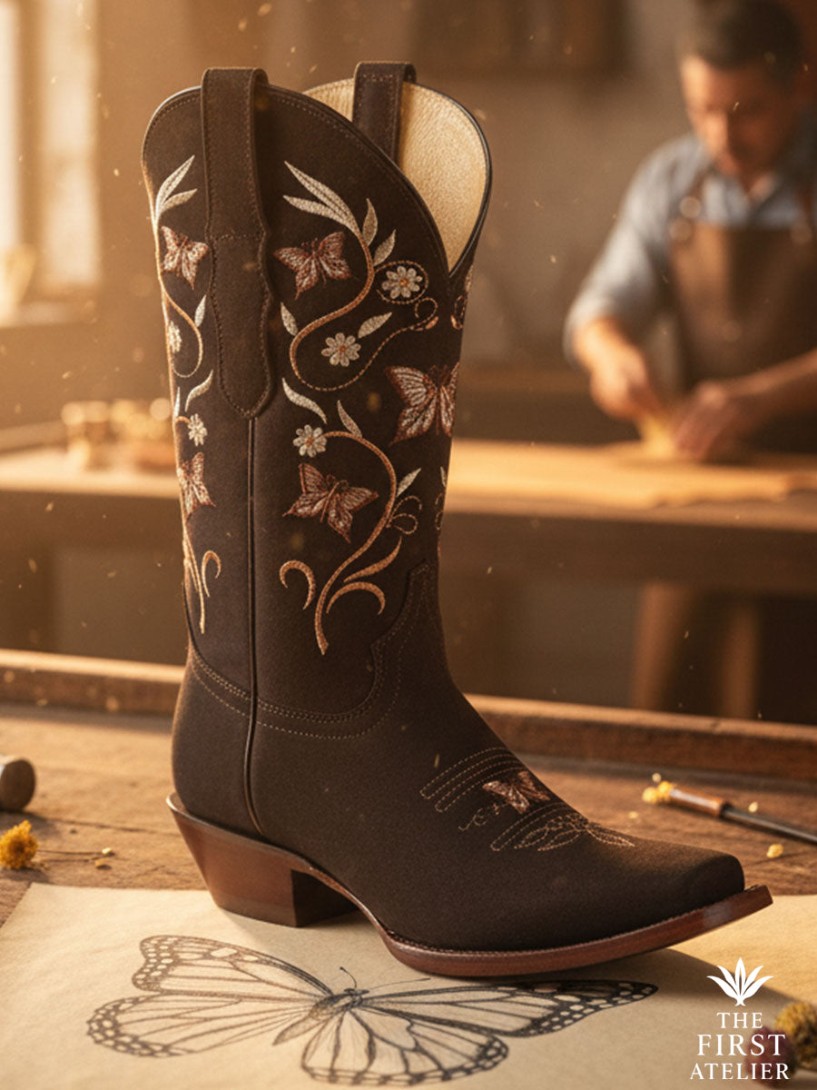 Close-up of La Mariposa Nocturna Boot — deep ebony leather with metallic butterfly embroidery in gold and rose tones, handcrafted by artisans in León, Guanajuato, Atelier No. 6.
